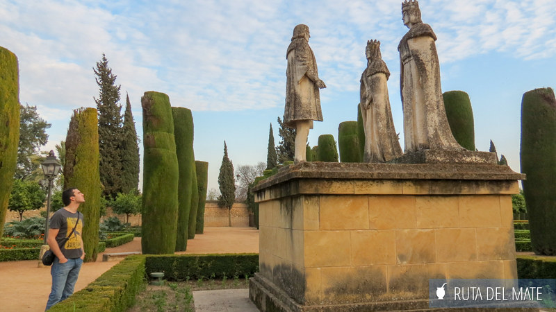 Juan observing the sculpture of Christopher Columbus and the Catholic Monarchs in the Alcazar of Cordoba.