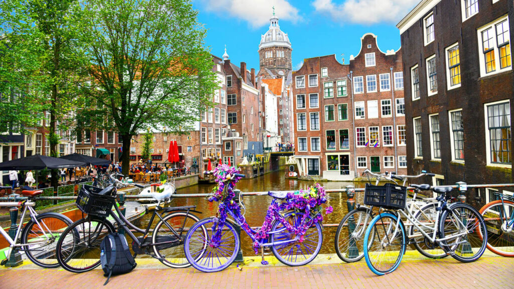 Bicycles leaning against a bridge on one of Amsterdam's canals