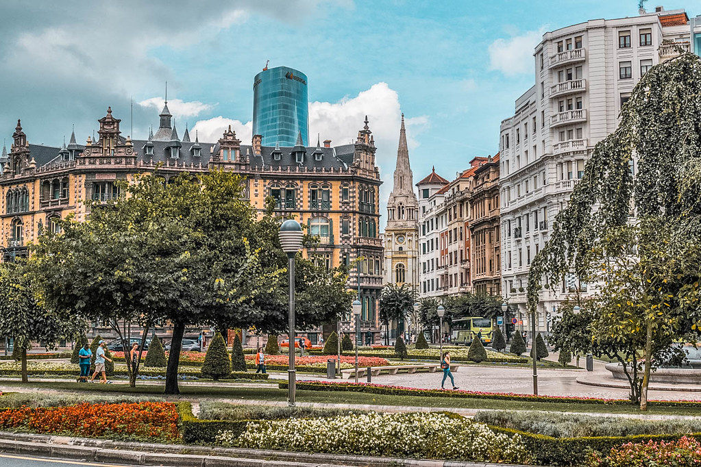 Buildings in the historic centre of Bilbao, with the modern structure of the Iberdrola tower looming in the background.