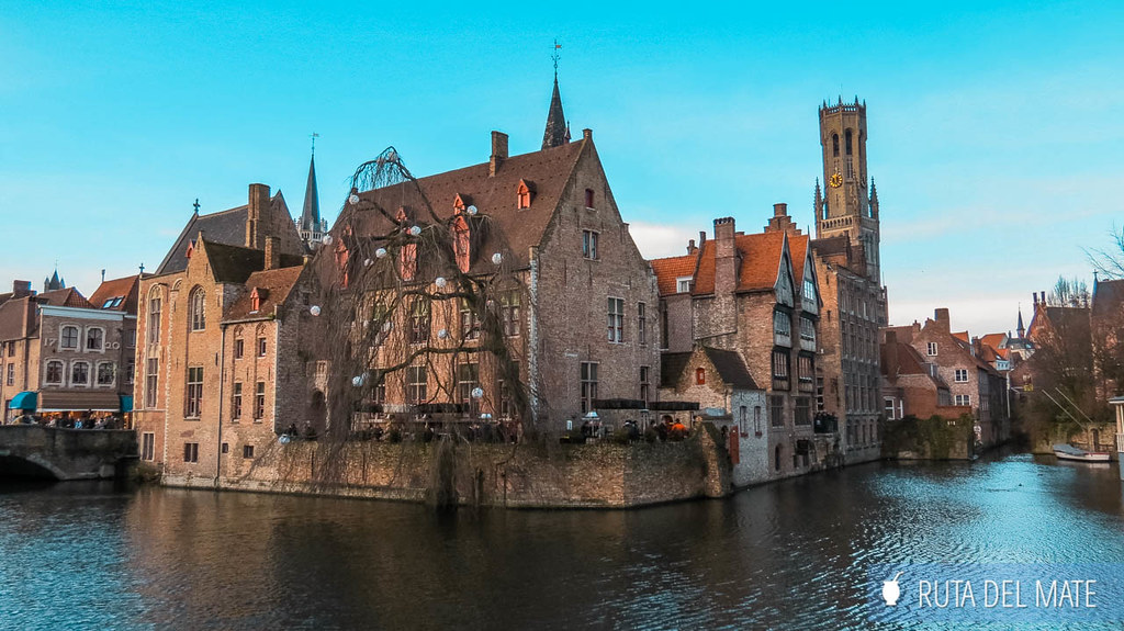 The canals of Bruges with the Rosary Quay, and the Belfry of Bruges in the background.